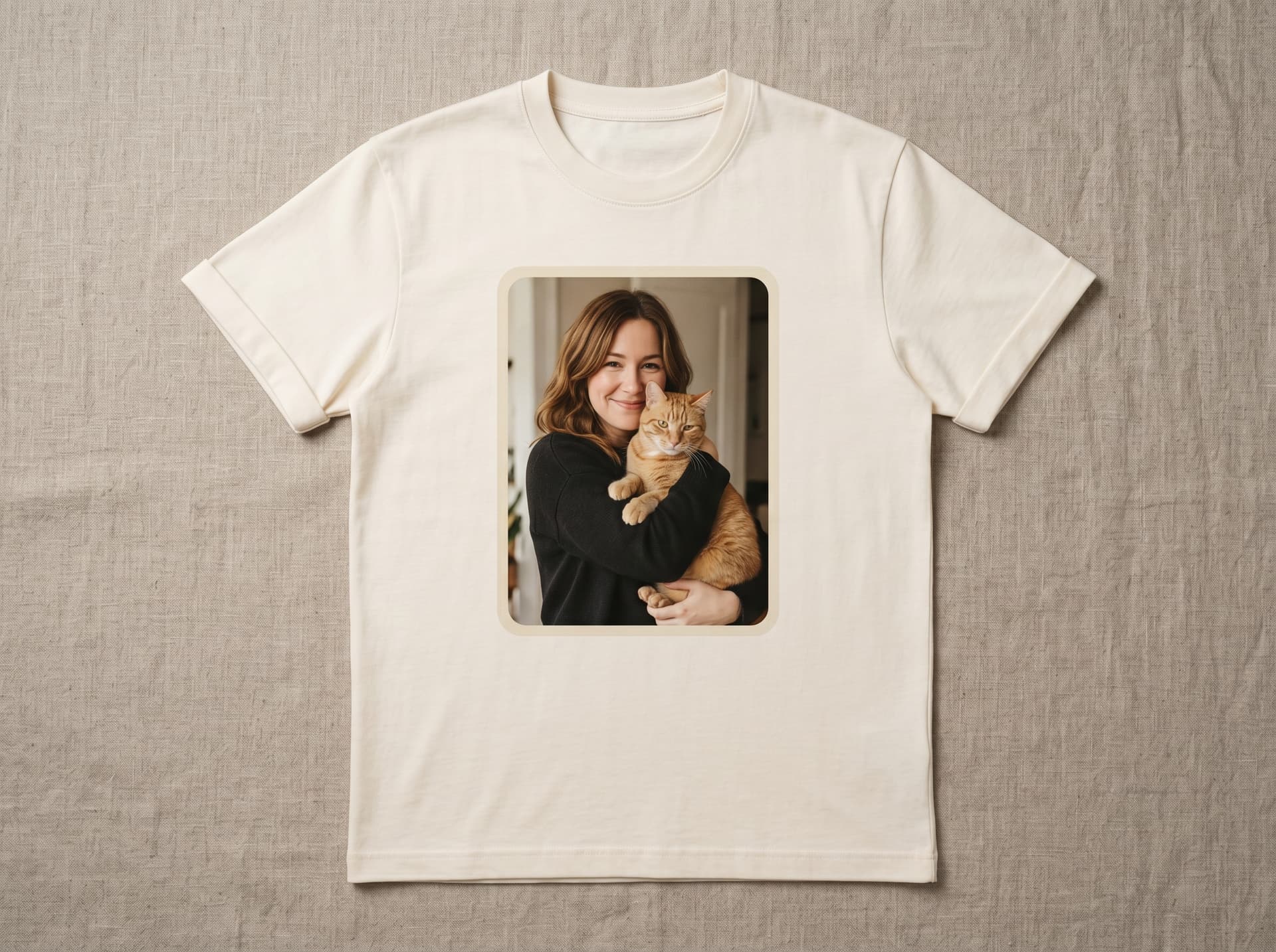 Premium cream cotton t-shirt, pressed flat, with a warm color bond portrait printed center-chest and soft rounded corners on the artwork — editorial product mockup